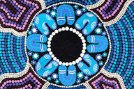 Aboriginal-style dot painting featuring a circular central design surrounded by blue and purple patterns, with repeated curved shapes radiating outward.